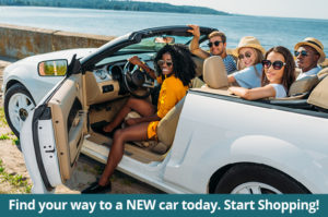 Shop for a new car today image of people in convertible by the sea