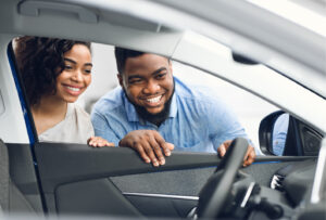 Picture of a couple looking at a new car